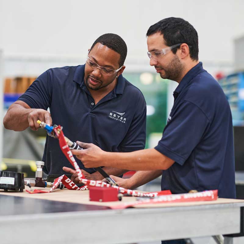 Workers are testing an assembly