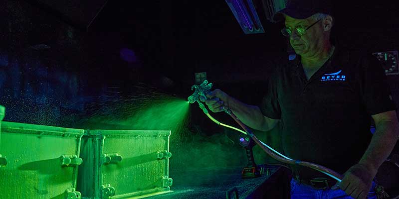 Seyer Employee Spraying Non-Destructive Coating